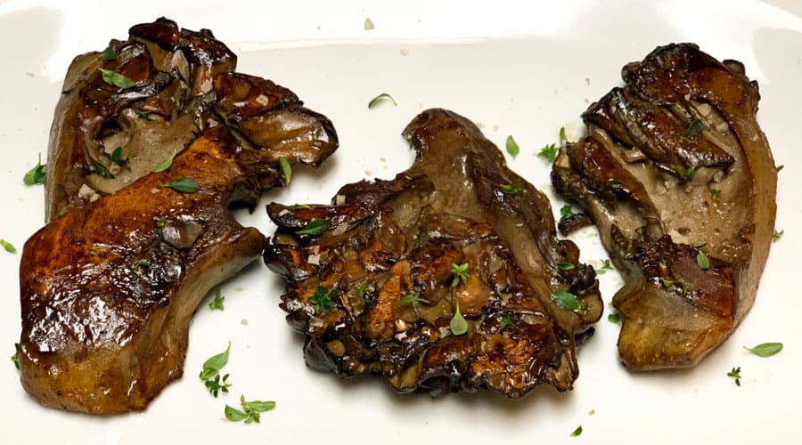 Recipe Red wine maitake mushroom steaks on a stovetop Tyrant Farms